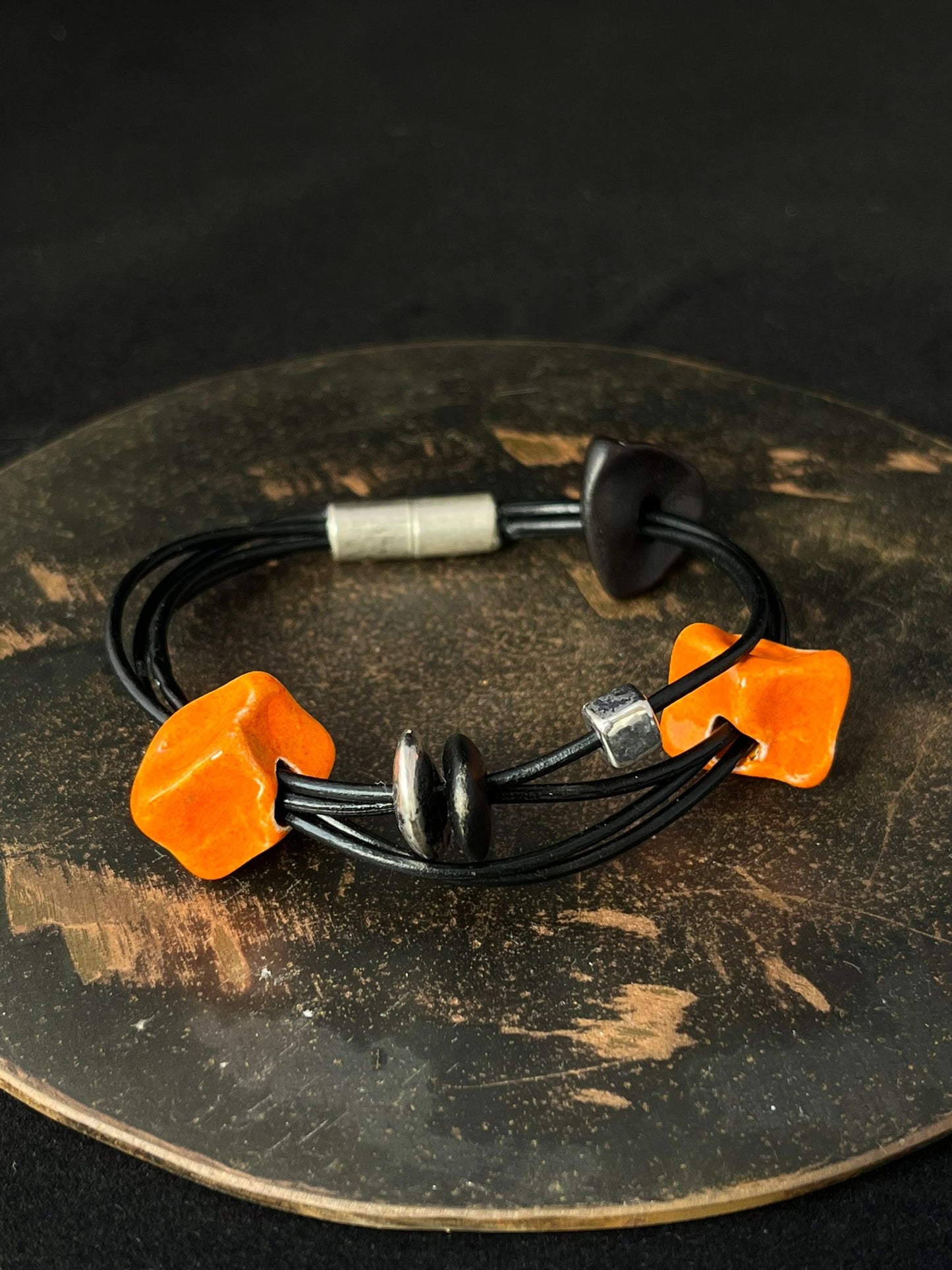 Ceramic Bead Bracelet in Orange, Black and Silver.